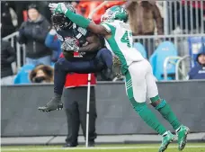  ?? MARK BLINCH/THE CANADIAN PRESS ?? James Wilder Jr., left, made a game-saving catch over Samuel Eguavoen in last year’s East Division final.