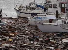  ?? (AP/Eric Gay) ?? Debris floats around damaged boats in a marina Sunday after Hurricane Hanna hit Corpus Christi, Texas. About 30 boats were lost or damaged in the storm at the marina. More photos at arkansason­line.com/727hanna/