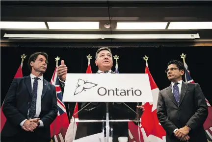  ?? CHRISTOPHE­R KATSAROV/THE CANADIAN PRESS ?? Minister of Finance Charles Sousa, centre, Attorney General Yasir Naqvi, right, and Minister of Health and Long-Term Care Eric Hoskins speak during a news conference where they detailed Ontario’s plans for recreation­al marijuana sales Friday.