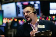  ?? MARK LENNIHAN — THE ASSOCIATED PRESS ?? Stock trader Michael Milano works Wednesday at the New York Stock Exchange.