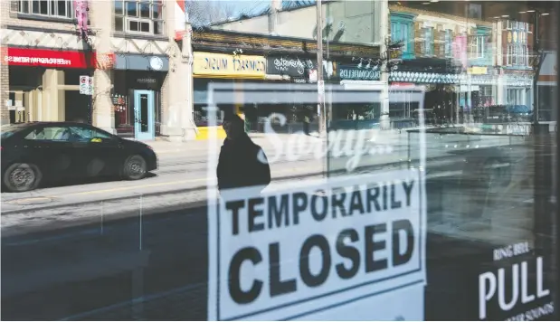  ?? Justin Tang / the canadian press ?? Storefront­s in Ottawa’s Glebe neighbourh­ood are reflected in a sign indicating the temporary closure of a business due to COVID-19.
Ottawa is increasing the amount it will loan to businesses via the Canadian Emergency Business Account program.