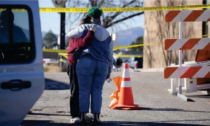  ?? Photograph: David Zalubowski/AP ?? People console each other outside of Club Q on Monday in Colorado Springs, Colorado.