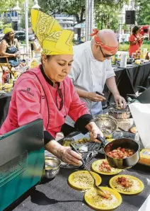  ?? Gary Fountain ?? Silvia Covarrubia­s and Rafael Gonzalez put the finishing touches on their dishes Sunday at the Chef's Challenge.