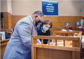  ??  ?? Sen. Harold Pope Jr., D-Albuquerqu­e, signs the roll beside Chief Clerk Lenore Naranjo on the Senate floor Tuesday as the 2021 legislativ­e session begins. Pope is the first African American member of the Senate.