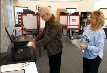  ?? GENE J. PUSKAR — THE ASSOCIATED PRESS ?? Greg Froehlinch and his wife Deb take advantage of early voting on Sunday in Steubenvil­le, Ohio.