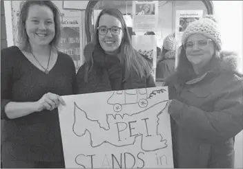  ?? SUBMITTED ?? Showing support for caravan workers at a solidarity gathering Thursday in Charlottet­own are, from left, Alanna Stewart, Ryanne Beatty and Lesley MacLean.