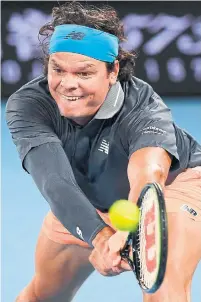  ?? WILLIAM WEST AFP VIA GETTY IMAGES ?? Canada’s Milos Raonic hits a return against Serbia’s Novak Djokovic during their match on Sunday at the Australian Open.