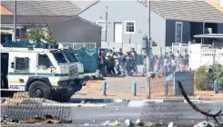  ?? (ANA) African News Agency ?? POLICE clash with Tafelsig residents protesting for food parcels. Tyres were burnt in AZ Berman Drive and police vehicles were stoned. |