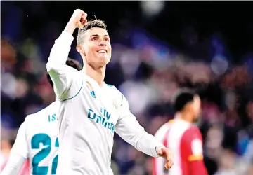  ?? — AFP photo ?? Real Madrid’s Portuguese forward Cristiano Ronaldo celebrates his fourth goal during the Spanish League football match between Real Madrid CF and Girona FC at the Santiago Bernabeu stadium in Madrid on March 18, 2018.