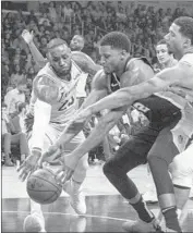  ?? Allen J. Schaben Los Angeles Times ?? LeBRON JAMES, left, and Josh Hart of the Lakers try to keep the ball away from Rudy Gay of the Spurs.