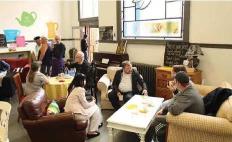  ?? MAFF POTTS/CAMERADOS ?? People gather inside Camerados, a space inside a library in a depressed seaside English town where people can share their stories and support.