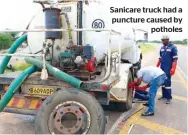  ?? PICS: KENNEDY RAMOKONE ?? Sanicare truck had a puncture caused by
potholes
Armstrong Gaborekwe and Ernest Letsholath­ebe