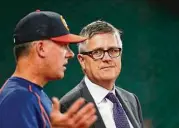  ?? Karen Warren / Houston Chronicle ?? Astros general manager Jeff Luhnow, right, is tasked with rebuilding a club that underachie­ved in 2016.