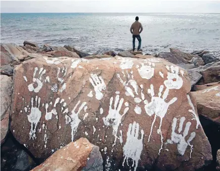  ?? Photo: REUTERS ?? The handprints­maybe a symbol of hope but coping with the number of refugees arriving in Europe is dividing countries.