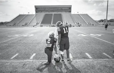  ?? Los Angeles Times/TNS ?? Mesquite High football players DeWayne Adams, left, and Vidal Allen, right, talk on the sideline Aug. 30 during a break in football practice in Mesquite, Texas. Slain student and athlete Jordan Edwards was a close friend of DeWayne’s, and Vidal Allen...