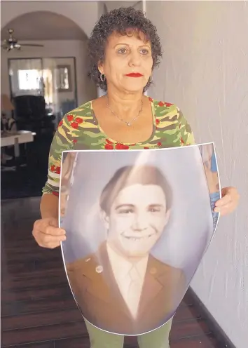  ?? ADOLPHE PIERRE-LOUIS/JOURNAL ?? Albuquerqu­e resident Rosemarie Franco holds a photo of her uncle U.S. Army Pvt. Porfirio C. Franco, who died as a prisoner of war in the Philippine­s during World War II. His remains were identified in September.