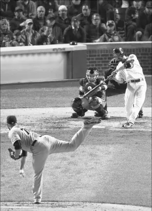  ?? CHARLES REX ARBOGAST/THE ASSOCIATED PRESS ?? Chicago Cubs pitcher Travis Wood (37) hits a home run Saturday in the fourth inning of Game 2 of the National League division series against the San Francisco Giants in Chicago.