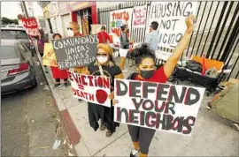  ?? Al Seib Los Angeles Times ?? FERNANDA Jimenez, left, Humberto Yauli, Fanny Ortiz and Carmina Calderon protest the eviction of tenants from a downtown L.A. apartment complex in 2021.