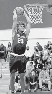  ?? JOHN MCCALL/STAFF PHOTOGRAPH­ER ?? Oxbridge Academy forward Ronique Spencer goes up for a dunk during warmups before Sunday’s action.