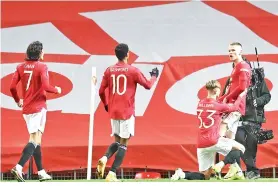  ?? - AFP photo ?? Manchester United’s Scottish midfielder Scott McTominay (R) celebrates with teammates after scoring his team’s first goal during the English FA Cup fifth round football match between Manchester United and West Ham United at Old Trafford in Manchester, north west England.