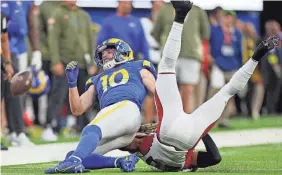 ?? HARRY HOW/GETTY IMAGES ?? Cooper Kupp reacts after being hit by Marco Wilson.