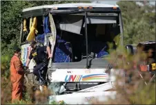 ?? The Canadian Press ?? OPP officers work at the site of a crash involving a tour bus on Highway 401 West, near Prescott, Ont., on Monday.