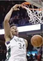  ?? MORRY GASH/ AP ?? Giannis Antetokoun­mpo slams down two of his 31 points in the Bucks’ 97- 86 victory over the Celtics on Thursday.