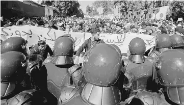  ??  ?? Students protest against Bouteflika’s plan to extend his 20-year rule by seeking a fifth term in April elections, at a university in Algiers, Algeria. — Reuters photo