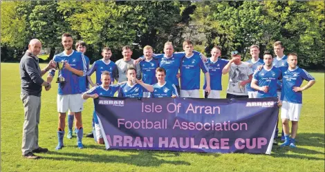  ?? 01_B20footy10 ?? Willie Anderson of Arran Haulage presents the cup to Brodick captain Matthew Dobson.