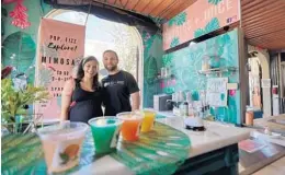  ?? ORLANDO SENTINEL RICARDO RAMIREZ BUXEDA/ ?? Jenny and Ben Falcone at their mimosa bar Bubbles + Juice in the Mount Dora Marketplac­e on March 3.“I feel like the spirit and the culture hasn’t changed, but there has been a bit of an infusion of like younger people around here,” said Jenny Falcone.