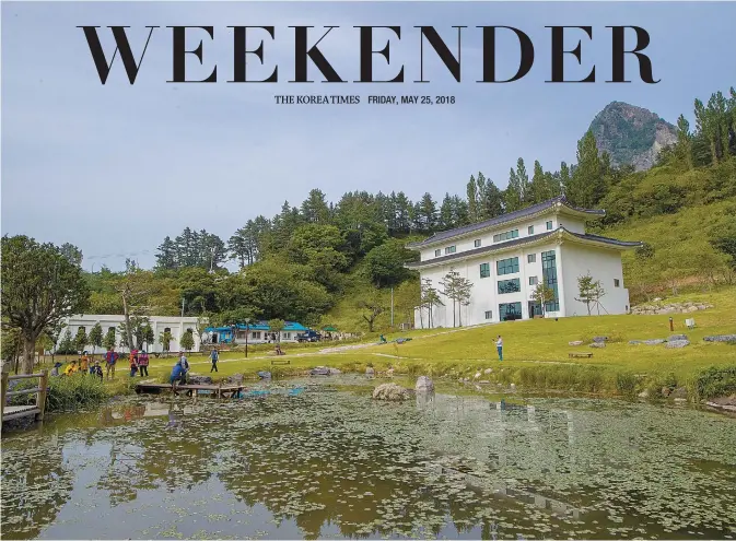  ?? Courtesy of PRM ?? Ulleung Heaven Art Center, right, opened on May 8, is next to his 100-year-old house he renovated. Located under awl-shaped Songgotbon­g Peak, it has a pond Lee dug himself.