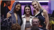  ?? ADAM HUNGER — THE ASSOCIATED PRESS ?? From left, LSU’s Angel Reese, Iowa’s Caitlyn Clark, and Stanford’s Cameron Brink, pose before the start of the WNBA draft on Monday in New York.