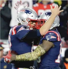  ?? STEVEN SENNE/AP ?? Patriots quarterbac­k Tom Brady joins Josh Gordon in celebratin­g their 55-yard connection for a touchdown in the fourth quarter Sunday night.