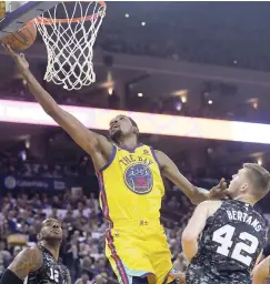  ?? AP ?? Golden State Warriors forward Kevin Durant (35) shoots between San Antonio Spurs forward LaMarcus Aldridge (left) and forward Davis Bertans (42) during the first half of an NBA basketball game in Oakland, California on Thursday. Warriors won 110-107.