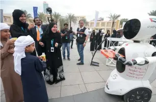  ??  ?? Children to adults interact with Wizo, the first 3D -printed robot in the world, made in the UAE during the UAE Drones for Good Award at the Internet City in Dubai on Saturday.