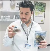  ?? Jay Jones ?? ARMEN YEMENIDJIA­N displays some of the wares at his medical marijuana shop in Las Vegas.