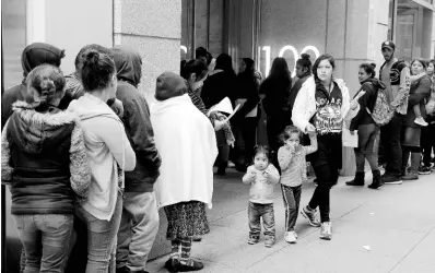  ?? AP ?? In this January 31, 2019, file photo, hundreds of people overflow on to the sidewalk in a line snaking around the block outside a US immigratio­n office with numerous courtrooms in San Francisco. Santa Clara and San Francisco have filed on suit against the Trump administra­tion over its new controvers­ial ‘public charge’ rule that restricts legal immigratio­n. This lawsuit is the first after the Department of Homeland Security’s announceme­nt on Monday, August 12, 2019, that it would deny green cards to migrants who use Medicaid, food stamps, housing vouchers, or other forms of public assistance.