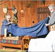  ?? STACI VANDAGRIFF/THREE RIVERS EDITION ?? Nancy Liles and Jeff Pulliam as Ethel and Norman Thayer uncover furniture at their family cabin in this rehearsal scene of On Golden Pond, which is set to open Friday evening at Center on the Square in Searcy.