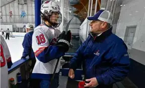  ?? JOSH REYNOLDS FOR THE GLOBE ?? Lynn Jets coach Brian Boisson (right) huddles with Anthony Alessi and stresses the fundamenta­ls after his shift vs. Medford.