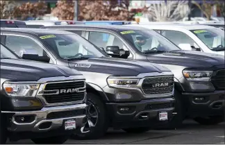  ?? DAVID ZALUBOWSKI — THE ASSOCIATED PRESS ?? The mileage increase comes as Americans continue to buy SUVs and trucks, like these at a Ram dealership in Littleton, Colo., and shift away from more efficient vehicles.