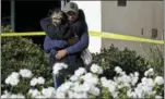  ?? ASSOCIATED PRESS ?? Mourners embrace outside the Thousand Oaks Teen Center, where relatives and friends gathered in the aftermath of a mass shooting, Thursday.