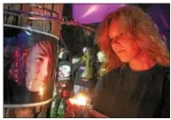  ?? DIGITAL FIRST MEDIA FILE PHOTO ?? Renee Paciello holds a candle as she looks at a photo of her son, Timothy, at the site where he was killed on Nov. 12, 2012, in Lower Pottsgrove.