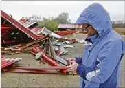  ?? BILL LACKEY / STAFF ?? Julie Reed, from the National Weather Service, takes notes as she surveys the damage to a barn in Enon Thursday.