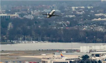  ?? AFP/Getty Images ?? A passenger aircraft takes off from Ronald Reagan national airport in Arlington, Virginia, on Tuesday. Photograph: Stefani Reynolds/