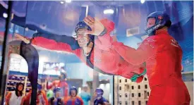  ?? [PHOTO BY SARAH PHIPPS, THE OKLAHOMAN] ?? Gil Herrera flies with the help of flight instructor Michael Plato during the All Abilities Night at iFly in Oklahoma City.