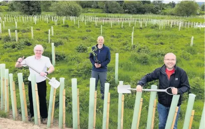  ??  ?? Planting trees at Kildean (from left) Cllr Jim Thomson, Stirling Council sustainabl­e developmen­t project officer Guy Harewood and Cllr Danny Gibson. Picture credit: Stirling Council.