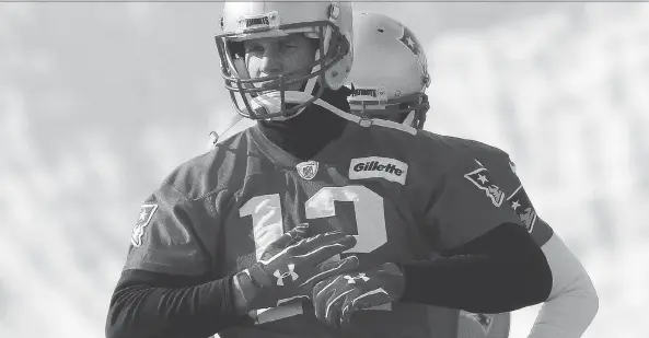  ?? BILL SIKES/THE ASSOCIATED PRESS ?? New England Patriots QB Tom Brady warmed up for practice Friday in Foxborough, Mass., but that’s the extent of public knowledge on his injured hand.