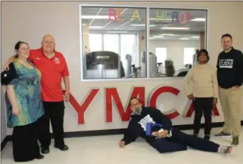  ?? MICHILEA PATTERSON — FOR DIGITAL FIRST MEDIA ?? From left to right, YMCA and Pottstown NAACP member Abby Weller-Hall, YMCA member Jim Frymoyer, Pottstown NAACP President Johnny Corson (laying on the floor), longtime Pottstown YMCA supporter and member Yvonne Jones and Pottstown YMCA Executive Director Scott Cusworth pose for a photo during the Pottstown YMCA grand re-opening and open house celebratio­n.