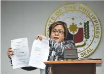  ?? AFP ?? SENATOR Leila M. de Lima shows documents asking the courts to quash cases against her during a press conference on Feb. 21.