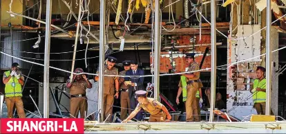  ??  ?? Devastatio­n: Security forces at the third-floor Table One restaurant inspect the wreckage